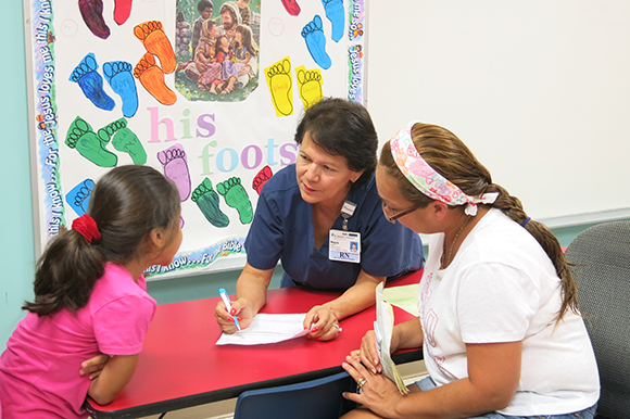 Madga Setzer, nurse at La Esperanza health clinic in Wimauma, assesses health needs.