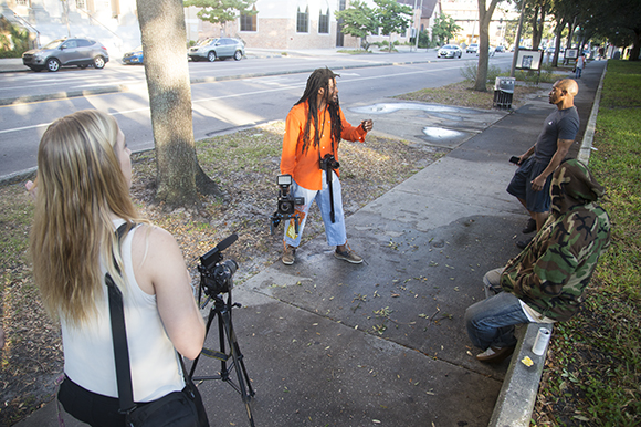 Jabaar Edmond directs Art In The City while USFSP Neighborhood News reporter Shelby Brown observes. 