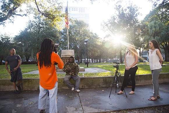Shelby Brown and Sara Al-Mutawa (R), observe and gather content of the filming of Art In The City. 