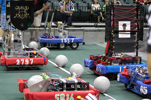 Student built robots face-off at the start of a match.