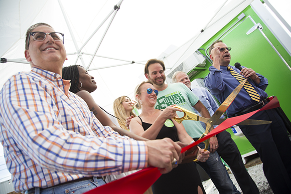 Mayor Rick Kriseman helps Shannon O’Malley and Brad Doyle cut the ribbon for the grand opening of Brick Street Farms in St. Pete.