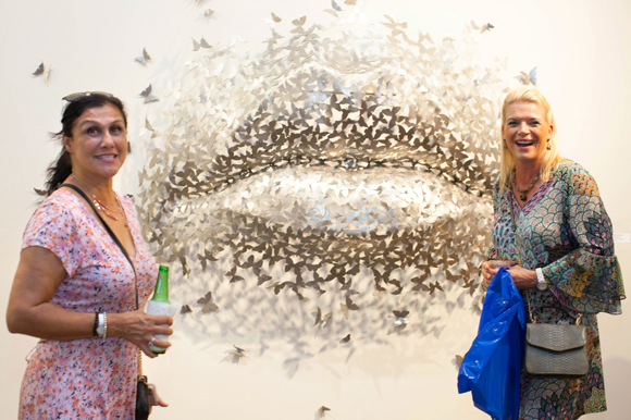 Saba Attari, left, and Kim Magnuson view 'Butterfly Kiss' by local and international sculptor Mark A