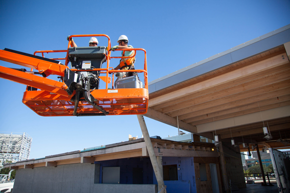 Roofers work on the new River Center at Julian B. Lane Riverfront Park.