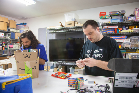Kyle Parker and Caleb Paine work on their Game Boy Zero project at Tampa Hackerspace.