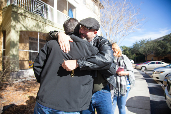 Marco Lopez, hugs Lee Estrada of Tampa. Lopez left Puerto Rico after losing his job to Hurricane Maria. 