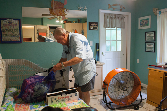 Ralph Dixon organizes his belongings that survived sewage-seeped flood waters in Yankeetown.