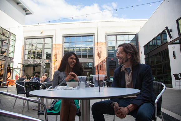 Juhi Kore and Jason Busto take a lunch break in the courtyard during opening day at Armature Works.
