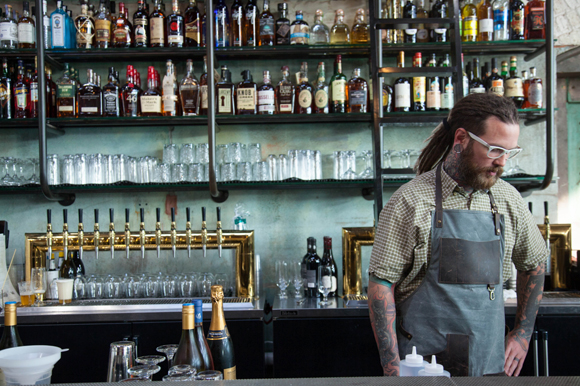 Brian Rohloff works the counter at Fine & Dandy, a cocktail emporium on opening day. 