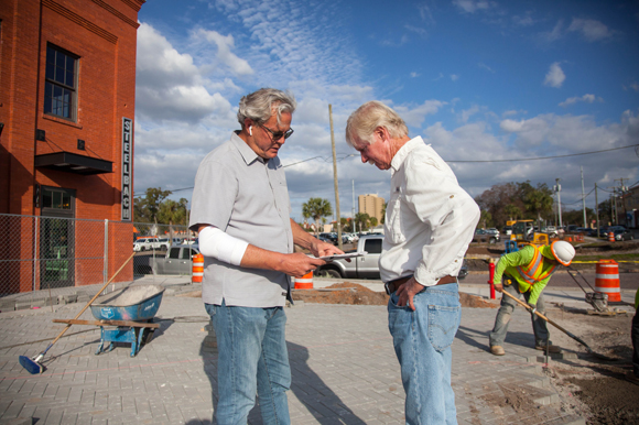 Adam Harden, co-owner of Armature Works, talks with Craig Hixon, a contractor at the new patio space.