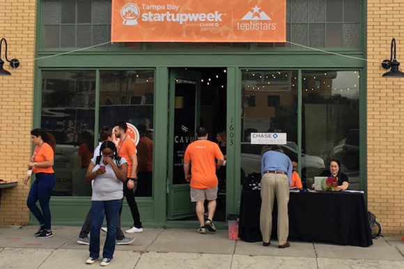 A steady flow of attendees enters and exits CAVU during Tampa Bay Startup Week.