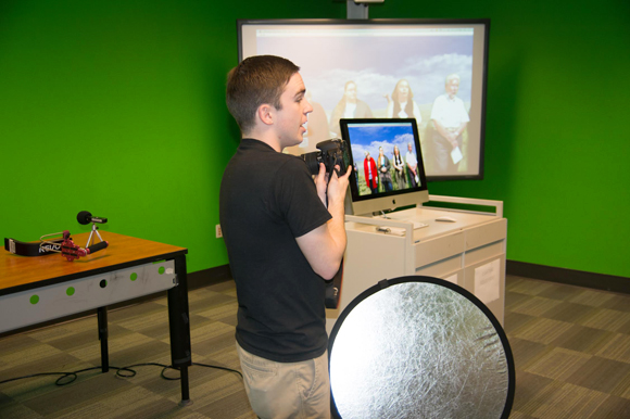 A student at the USF Library Digital Media Commons conducts a presentation.