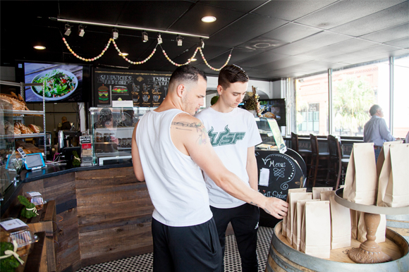 (L-R) E.J. Deleon, and Grayson Schiff-Clark look at a bag of Piquant espresso.