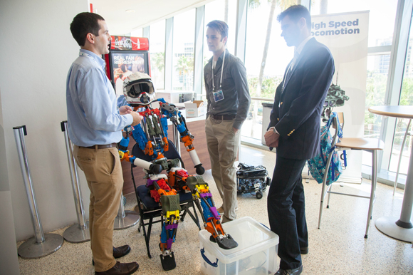 Dr. Robert Griffin, left, of IHMC Robotics talks with Johnny Coutant, and Christopher Eifler about humanoid robot Nadia made to be a disaster responder, and fire fighter.