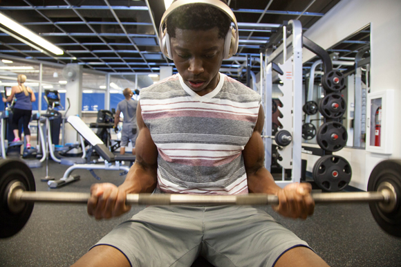 Derozier St. Fleur lifts weights inside the gym at the renovated JCC.