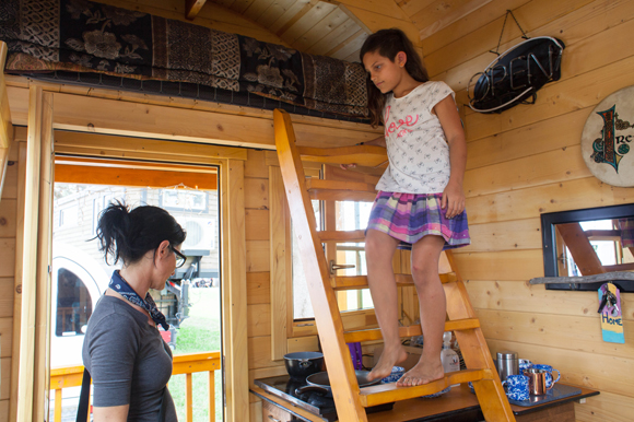 Erika Greco, and her daughter Nicole, 9, look through a log cabin built by Unforgettable Tiny House.