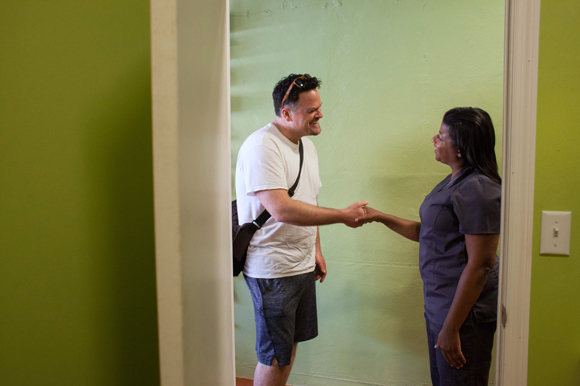 Eric Shippie greets Dr. Natalie Ellis, a licensed medical marijuana doctor, outside her office.