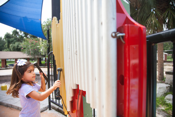 Maite Castillo, age 3, plays instruments at Macfarlane Park in West Tampa.