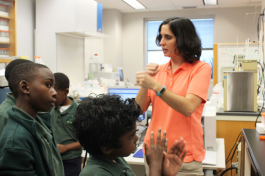 Kelly Quinn explains to Academy Prep students how the water samples they collected will be analyzed in the lab.