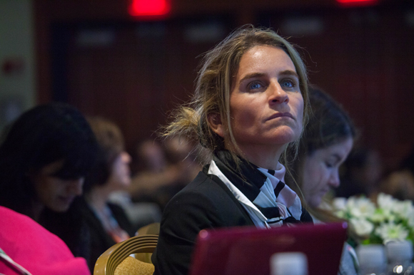 A woman looks on during the talk on translational research - building the gap from campus to community.