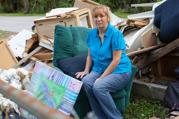 Mary Parker, a storm surge victim from Hurricane Hermine, sits amongst wreckage from her home in Crystal River.