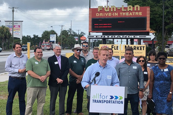 Tyler Hudson speaking at an All For Transportation news conference.