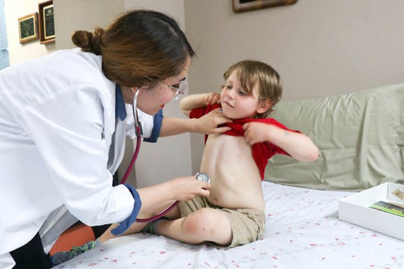 Claudia Gaefke, an MD Allergy and Immunology Fellow, performs a check up on Harry Coleman IV, age 5, who is undergoing treatment aimed to build tolerance to peanuts to lessen the effects of his peanut allergy.