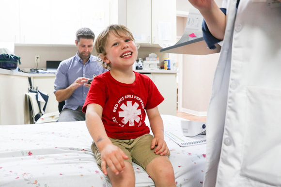 Harry Coleman III, waits with his son Harry Coleman IV, who is the youngest patient in a clinical study group.