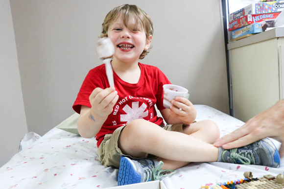 Coleman laughs while eating his peanut snack where previously he couldn't ingest 1/100th of a peanut without an allergic reaction.