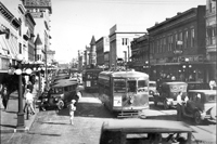 A bustling Franklin Street in 1925. Two streetcars are seen operating together, known as a "double header".