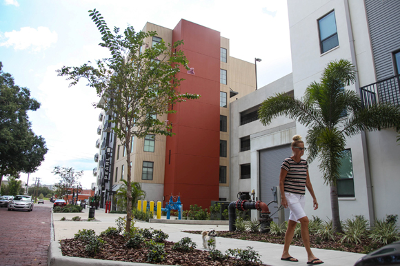 A Pearl resident walks past the newly designed wrap parking structure.