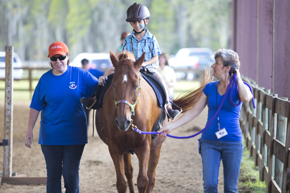 Shawn Webber, 7, enjoys the ride around the arena at Quantum Leap Farm.  