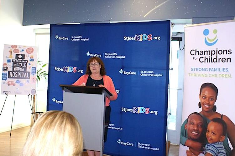 Amy Haile, Executive Director of Champions for Children in Tampa, announces launch of Talk, Read, Sing initiative.