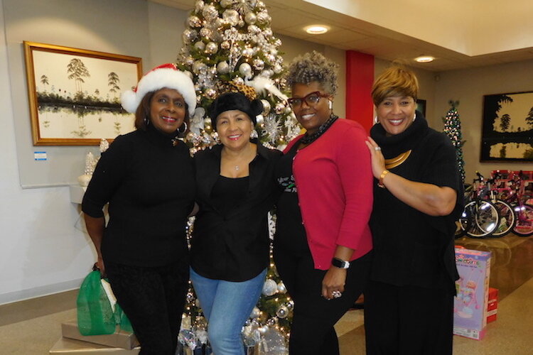 Dr. G. Carter Woodson African American Museum board members: Yolanda Judson; Dana Battle, chair; and Frechette Bradley; with Terri Lipsey Scott, executive director of the museum.