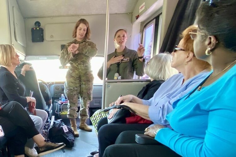 Airman First Class Sterling Sutton, 6th Air Refueling Wing, Public Affairs Specialist, keeps a tour on time as Capt. Allison Fracasso, 91st Air Refueling Squadron pilot, greets guests. Some 7 percent of the Air Force’s about 11,000 pilots are women.