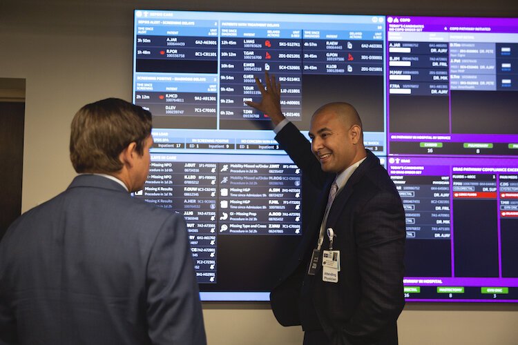 Florida Gov. Rick DeSantis listens as Peter Chang M.D., VP of care transitions at Tampa General Hospital, gives him a tour of Tampa General Hospital's new CareComm Command Center.