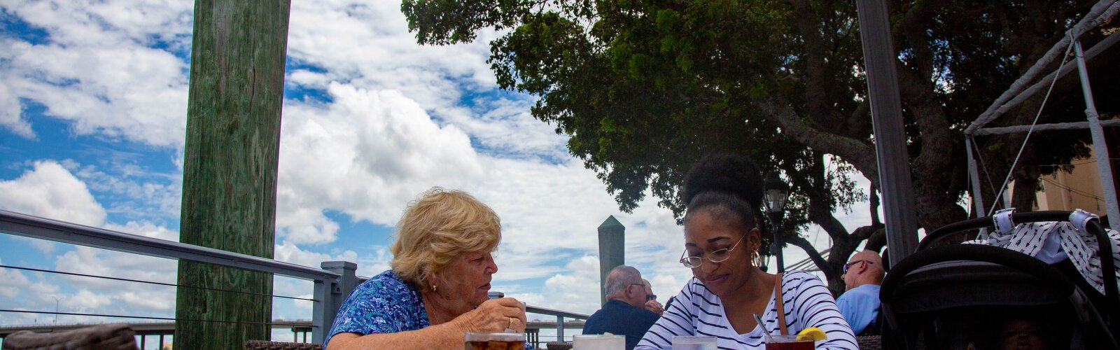 Pat Benson has lunch with Julliana Essengue and her young baby who recently moved here from Cameroon in Africa. 