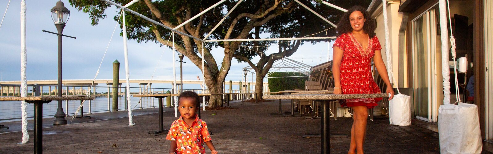 A woman and her son take play outside among the expansive water views in downtown Bradenton.