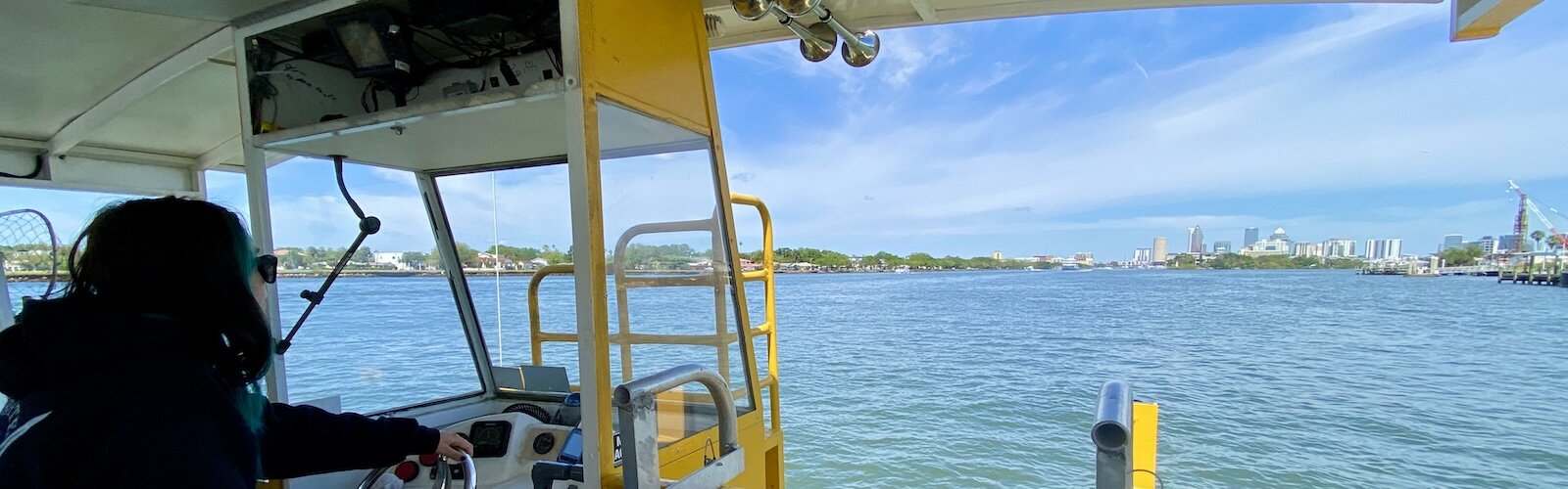 The downtown Tampa skyline comes into view as a student pilot steers a Pirate Water Taxi in open waters (with a licensed pilot supervising).