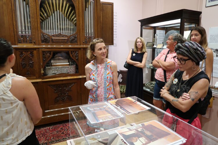  Curator Susan Carter providing information on an Archives Awareness Week exhibit at the Henry B. Plant Museum.