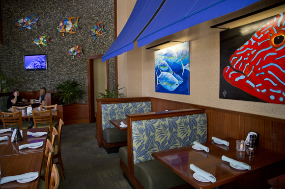Paintings by B.C. Woo and metal art by Clayton Swartz adorn the walls at 400 Beach Seafood & Tap House.