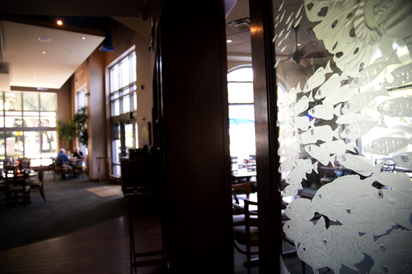 Etched glass art by Sam Brewster is built into the room dividers at 400 Beach Seafood & Tap House.