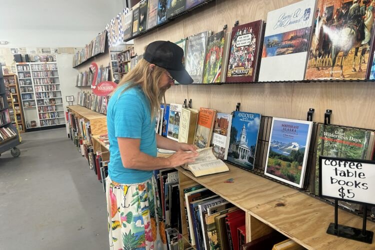 The Book Rescuers' George Brooks inspects a book