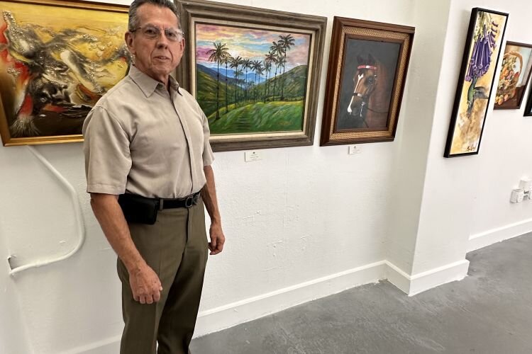 Coalition of Hispanic Artists member Carlos Soto with some of his artwork