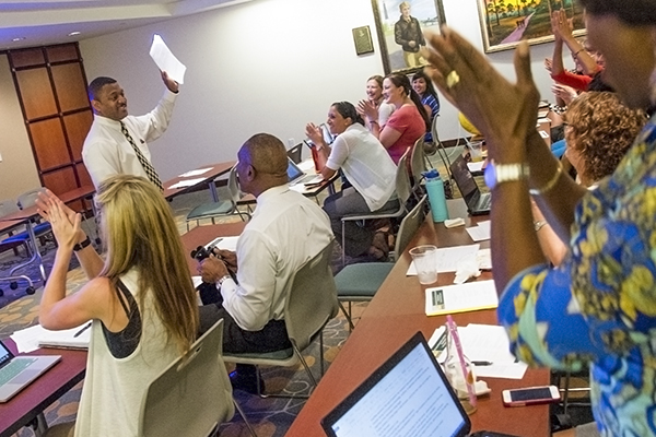 Dr. Kevin Sneed, Dean of the USF College of Pharmacy, shares accreditation letter with faculty members.