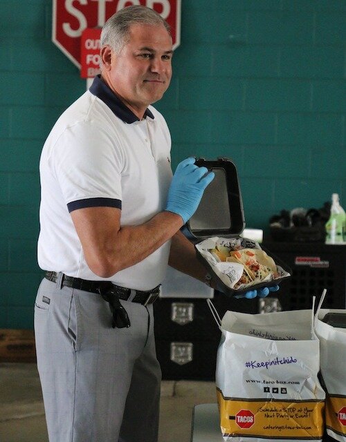 New Clearwater Mayor Frank Hibbard helps deliver meals to police officers on duty.