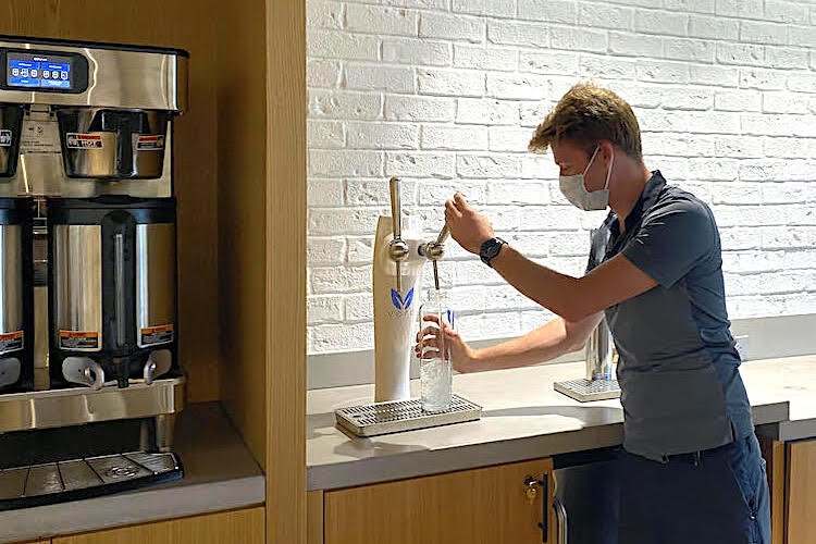 Ryan Malize, CEO of Pinellas Computers, rehydrates from an 8-stage filtered water dispenser.