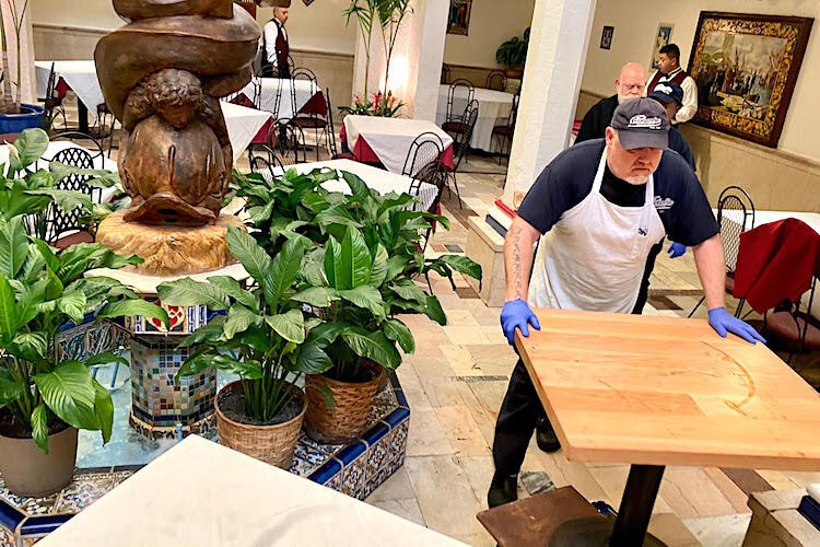 Staff at Columbia Restaurant in Ybor City move tables farther apart in the historic Patio dining room per guidelines about social distancing. A few days later, the restaurant and the rest of the Columbia Restaurant Group locations had to close.