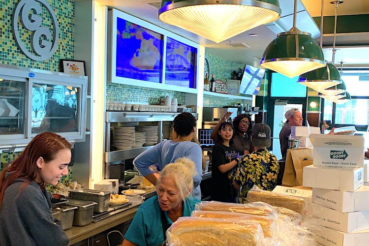 Team members at Goody Goody Burgers in Hyde Park Village create food assistance packages on March 21, 2020, for furloughed employees after Florida Gov. Ron DeSantis orders the state’s restaurants to cease dine-in service.