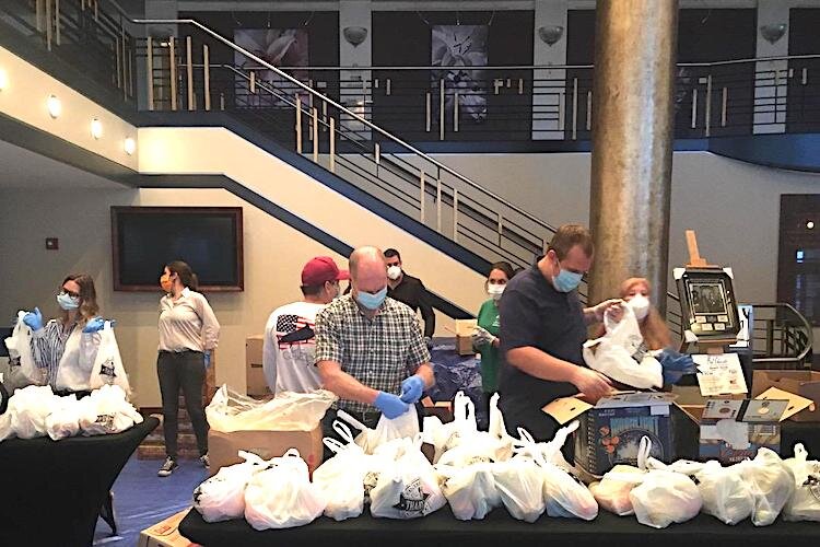 The lobby of the Mahaffey Theater serves as staging site for volunteers packaging food for Meals on Wheels for Kids.