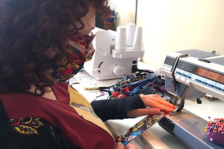 Sandra Botero sews her super hero masks for healthcare workers.